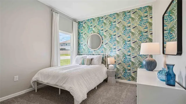 a bedroom with a bed and a painting on the wall