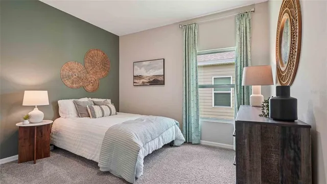 a bedroom with a bed and a flat tv screen on a dresser