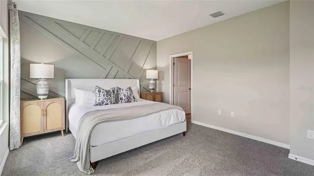 a bedroom with a bed and a lamp
