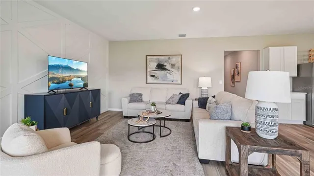 a living room with furniture a rug and wall painting