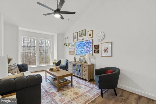 a view of a bedroom with furniture and wooden floor
