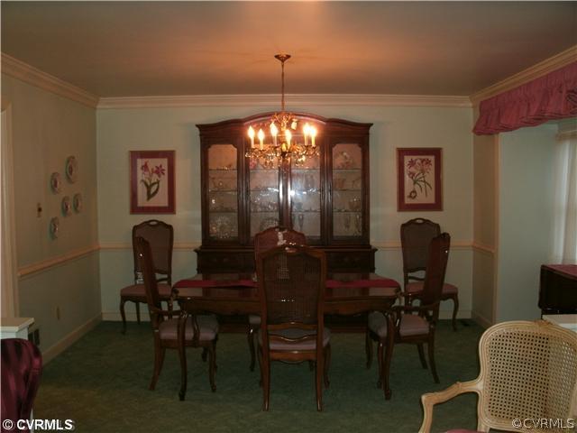4100 Cresthill Road Chester, VA 23831 - Photo 2 of 7 a view of a dining room with furniture and chandelier