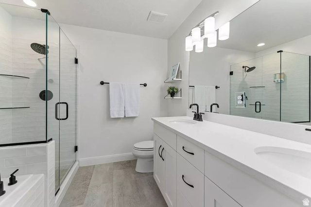 1166 North Riviera Alley Washington, UT 84780 - Photo 12 of 26 Bathroom with double vanity, recessed lighting, a stall shower, a tub to relax in, and light wood-style floors