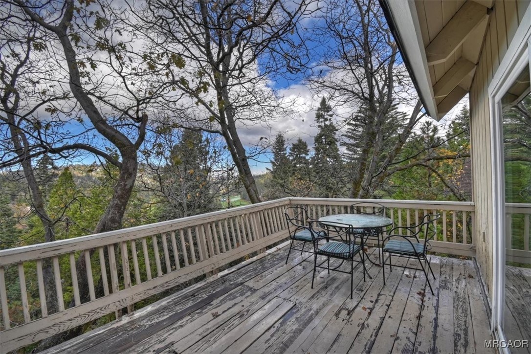 26822 Huron Road Lake Arrowhead, CA 92391 - Photo 19 of 38 a view of balcony with wooden floor and outdoor seating