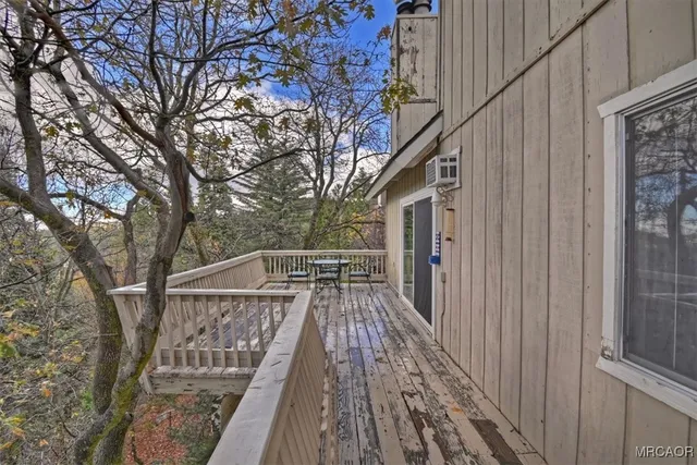 a view of balcony with wooden floor and fence