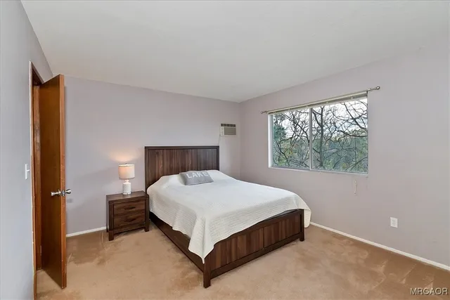 a bed sitting in a bedroom next to a window