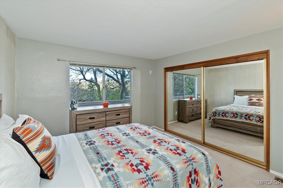 26822 Huron Road Lake Arrowhead, CA 92391 - Photo 31 of 38 a bedroom with a bed and a window