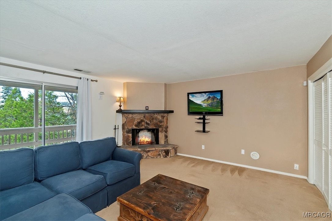 26822 Huron Road Lake Arrowhead, CA 92391 - Photo 33 of 38 a living room with furniture and a flat screen tv