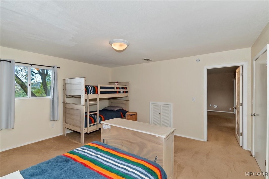 26822 Huron Road Lake Arrowhead, CA 92391 - Photo 37 of 38 a room with furniture and a book shelf