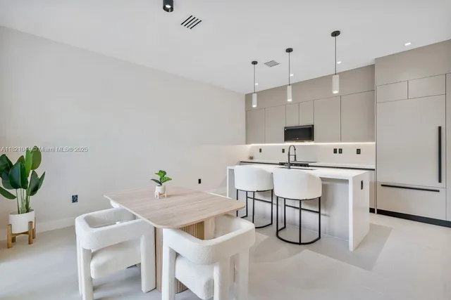 a bedroom with a bed and a flat tv screen on dresser