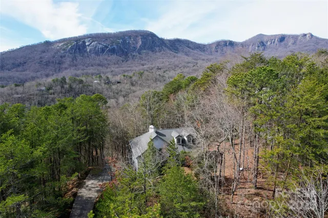 an aerial view of a house and mountain view