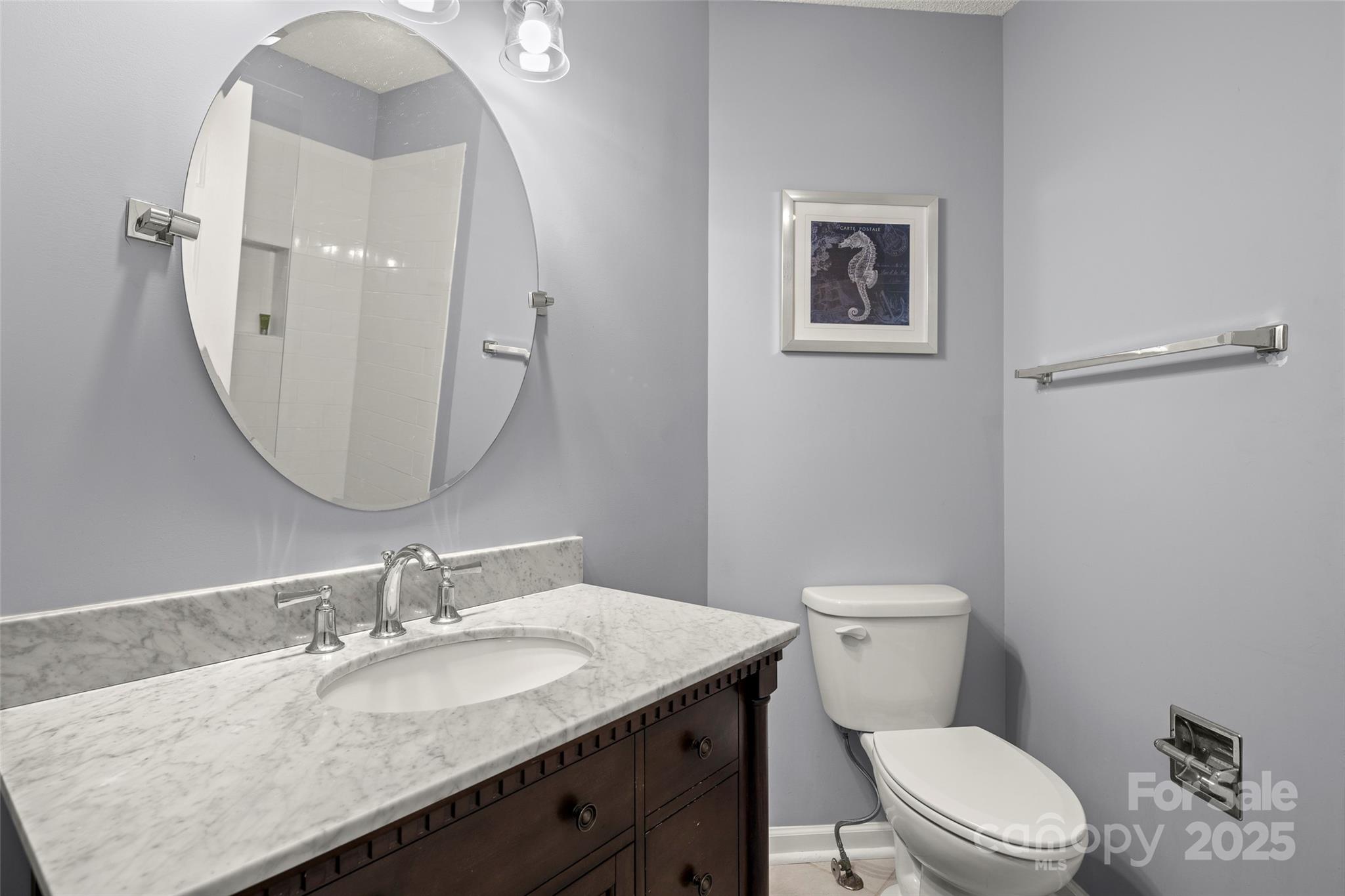 212 Ridgeway Road Lake Lure, NC 28746 - Photo 19 of 44 a bathroom with a granite countertop toilet a sink and mirror