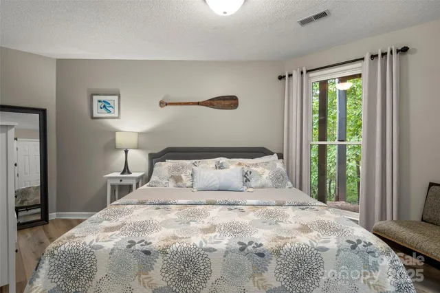 a bedroom with a large bed and a window