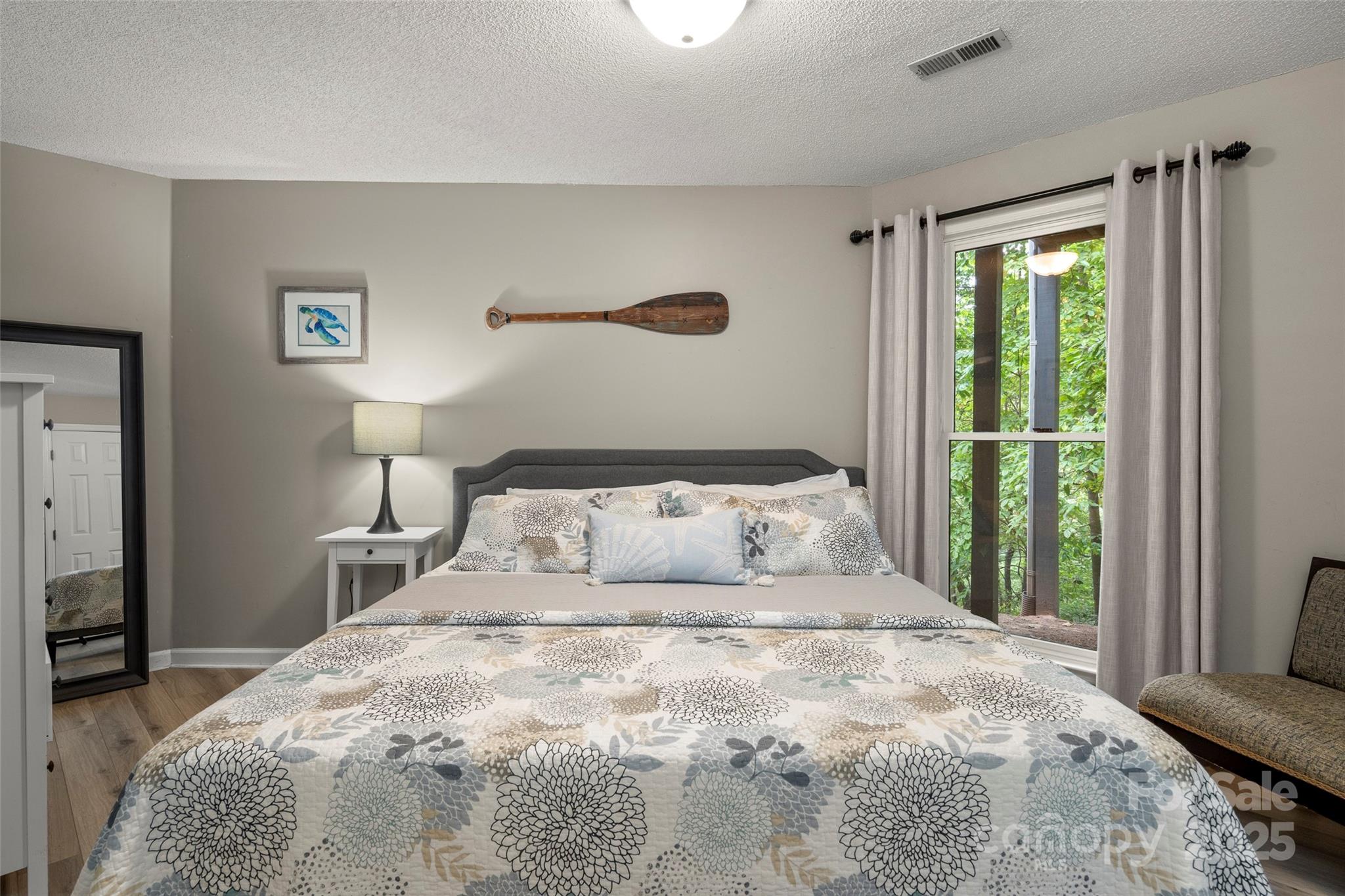212 Ridgeway Road Lake Lure, NC 28746 - Photo 31 of 44 a bedroom with a large bed and a window