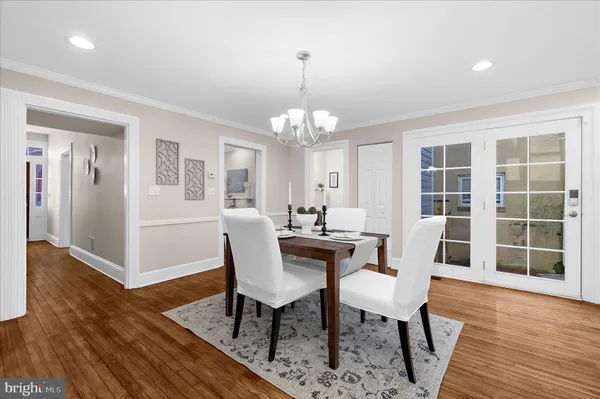 a large kitchen with stainless steel appliances granite countertop a stove a sink a dining table and chairs