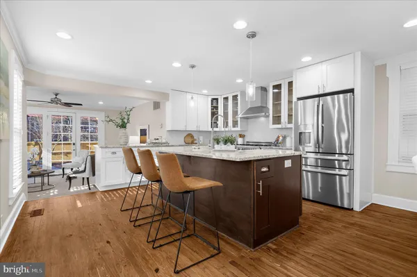a kitchen with granite countertop a sink a counter top space and stainless steel appliances