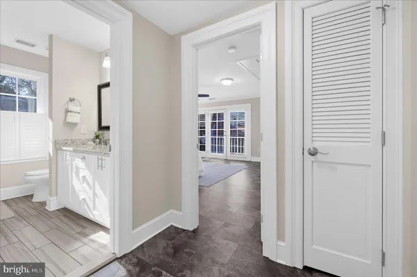 a bathroom with a granite countertop sink a mirror and a bathtub
