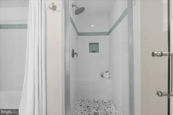 a spacious bathroom with a granite countertop sink a toilet and a large mirror
