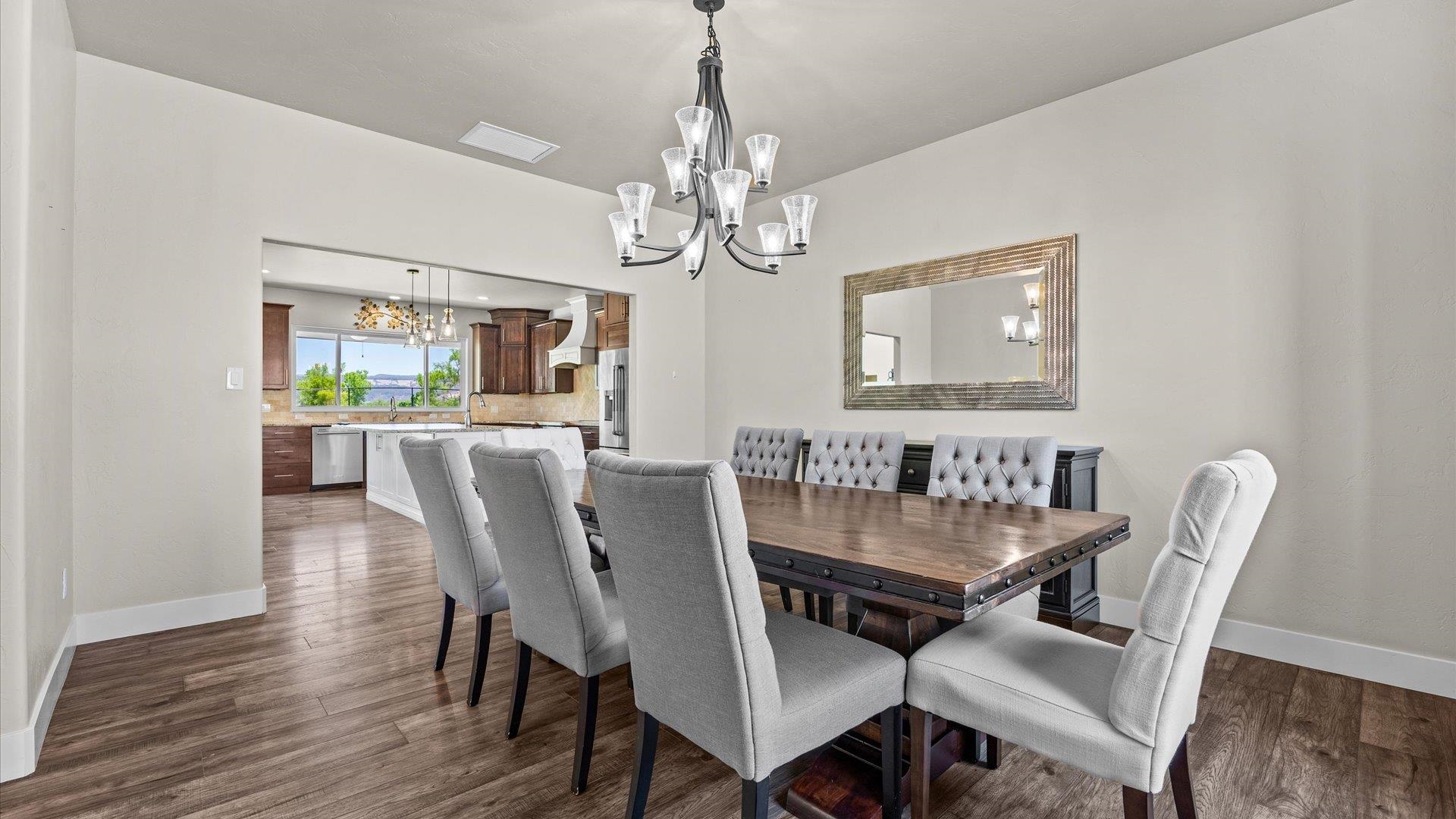 2041 J J 1/2 Road Fruita, CO 81521 - Photo 12 of 42 a dining room with furniture a chandelier and wooden floor