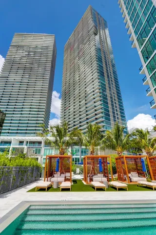 a spacious bedroom with a bed and a large window
