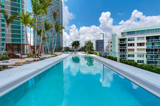 a view of a balcony with a floor to ceiling window next to a city view