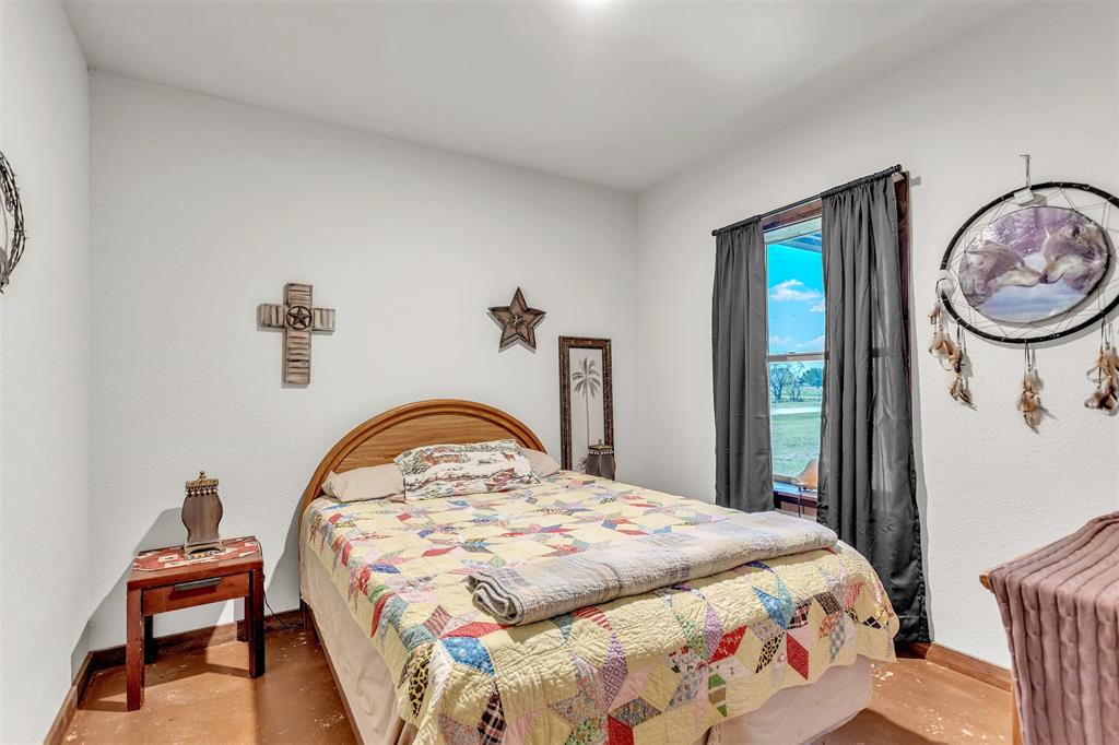 13831 Friendship Road Pilot Point, TX 76258 - Photo 17 of 31 a bedroom with a bed and a mirror