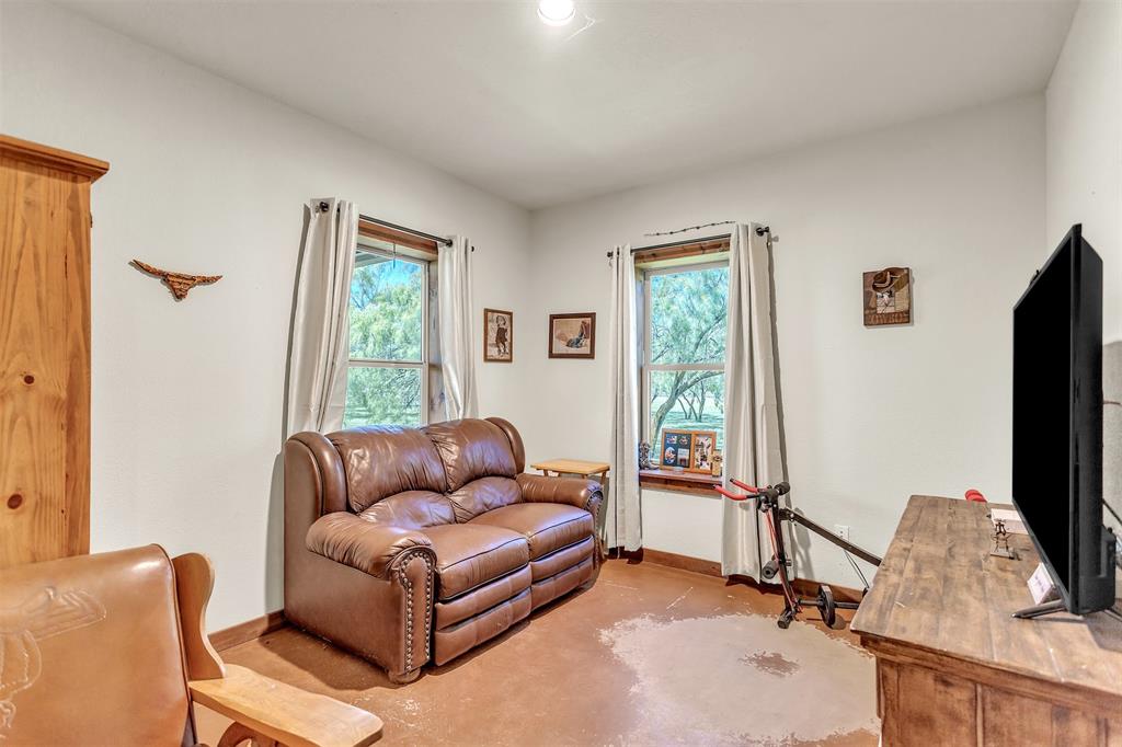 13831 Friendship Road Pilot Point, TX 76258 - Photo 19 of 31 a living room with furniture and a flat screen tv