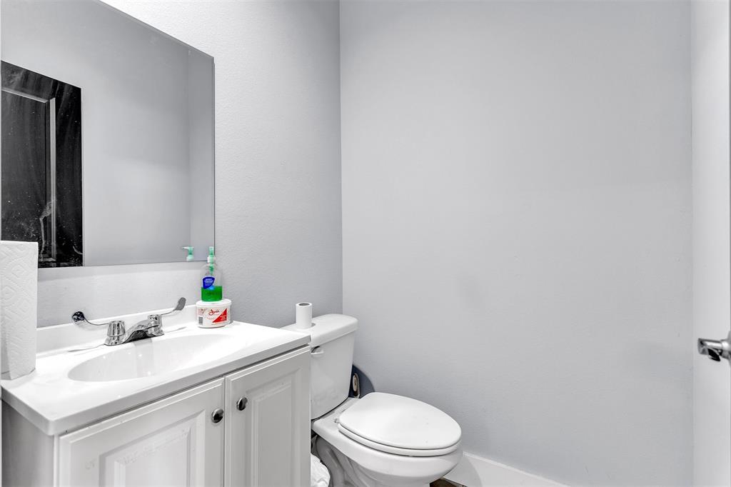 13831 Friendship Road Pilot Point, TX 76258 - Photo 22 of 31 a bathroom with a sink a toilet and mirror
