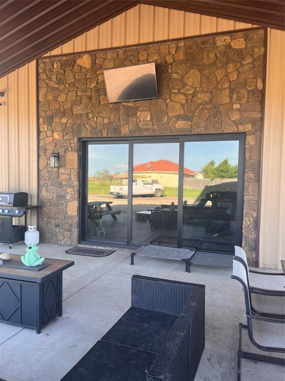 13831 Friendship Road Pilot Point, TX 76258 - Photo 5 of 31 a living room with couch and a floor to ceiling window
