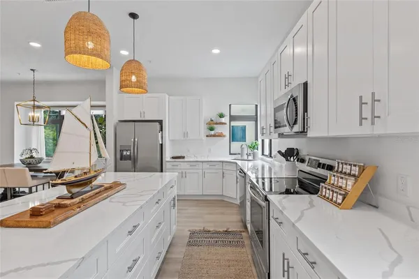 a kitchen with a sink stove and cabinets