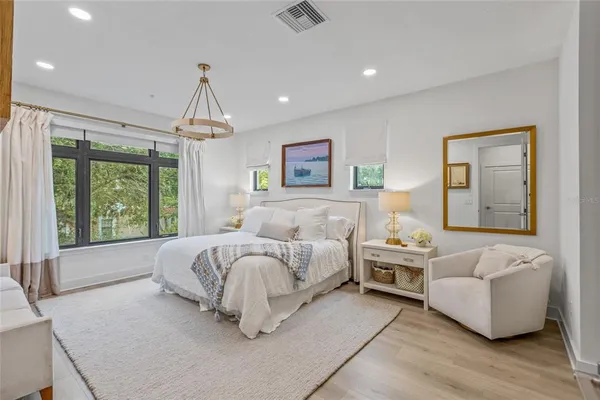 a spacious bedroom with a bed and a couch