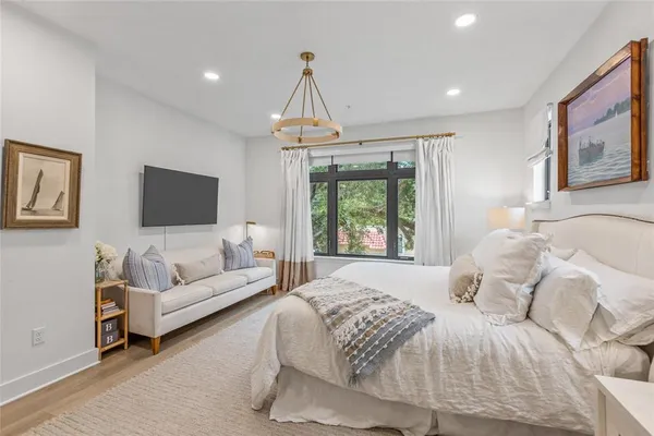 a bedroom with a large bed and a couch