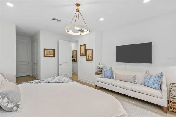 a bedroom with a bed and a couch