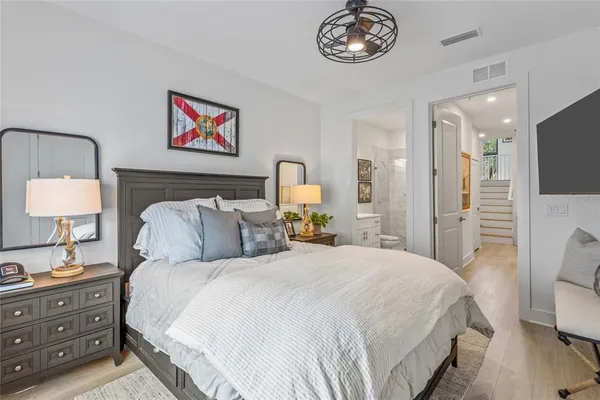 a bedroom with a bed and wooden floor