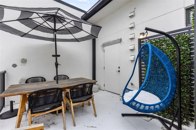 a patio with a table and chairs