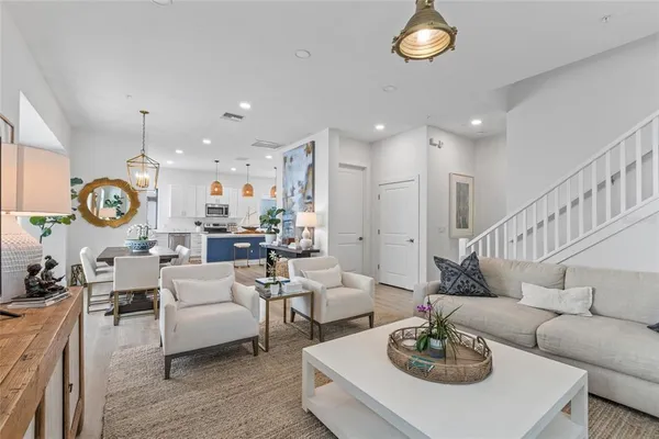 a living room with furniture kitchen view and a table