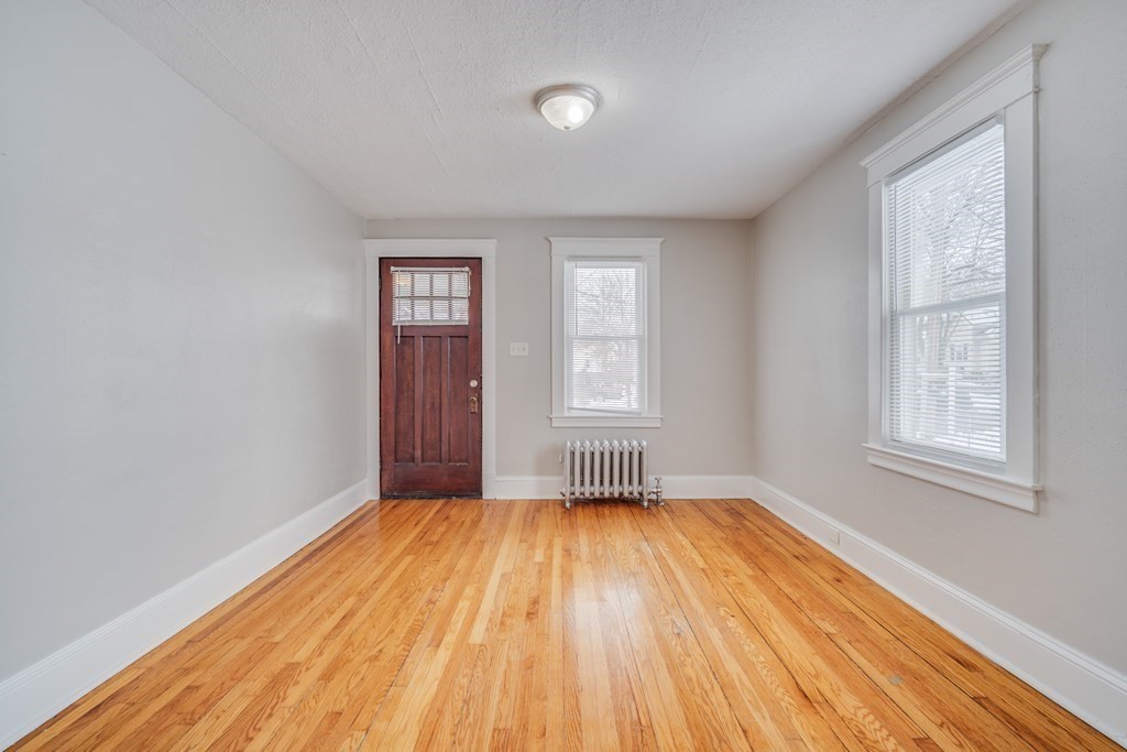 35 Stuart Street Springfield, MA 01119 - Photo 14 of 34 an empty room with wooden floor and windows