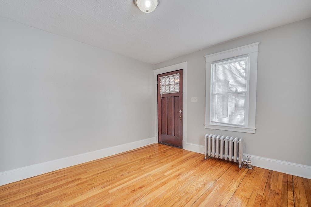 35 Stuart Street Springfield, MA 01119 - Photo 15 of 34 a view of an empty room with wooden floor and a window