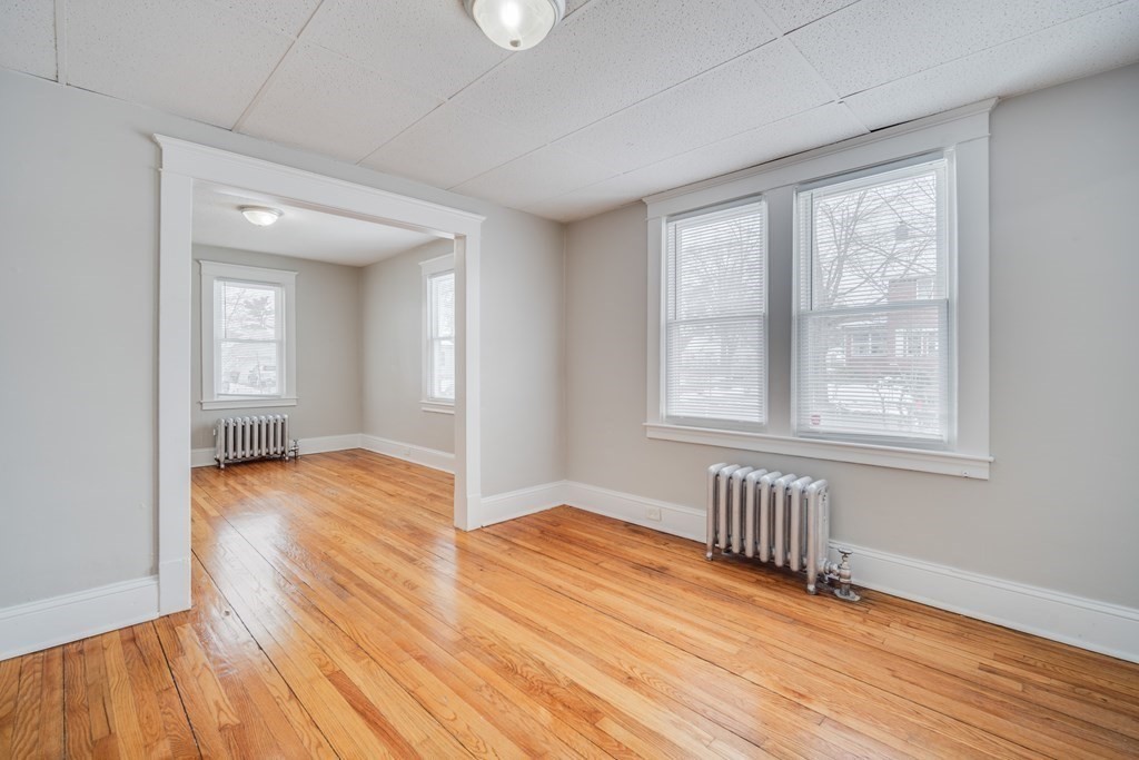 35 Stuart Street Springfield, MA 01119 - Photo 19 of 34 a view of an empty room with wooden floor and a window