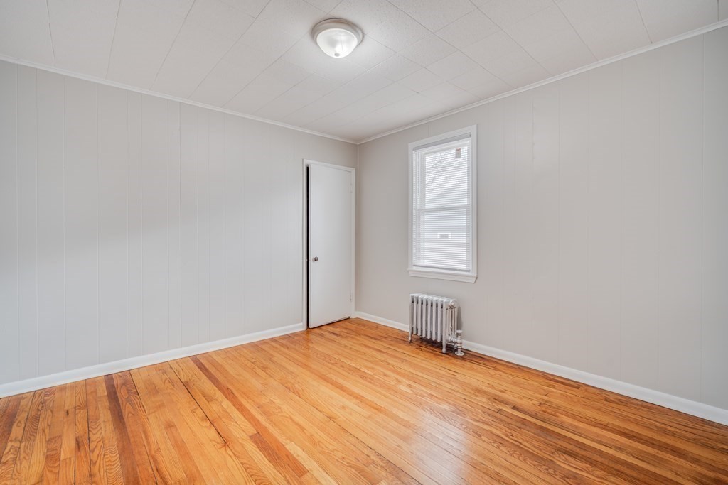35 Stuart Street Springfield, MA 01119 - Photo 22 of 34 an empty room with wooden floor and windows