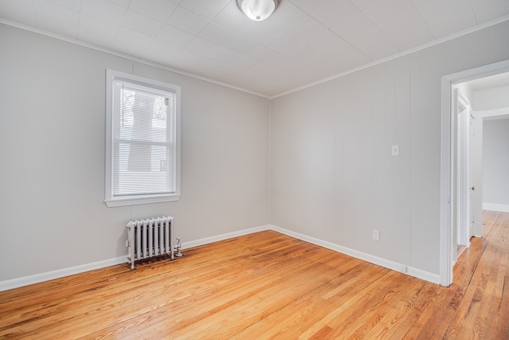 35 Stuart Street Springfield, MA 01119 - Photo 24 of 34 a view of an empty room with wooden floor and a window