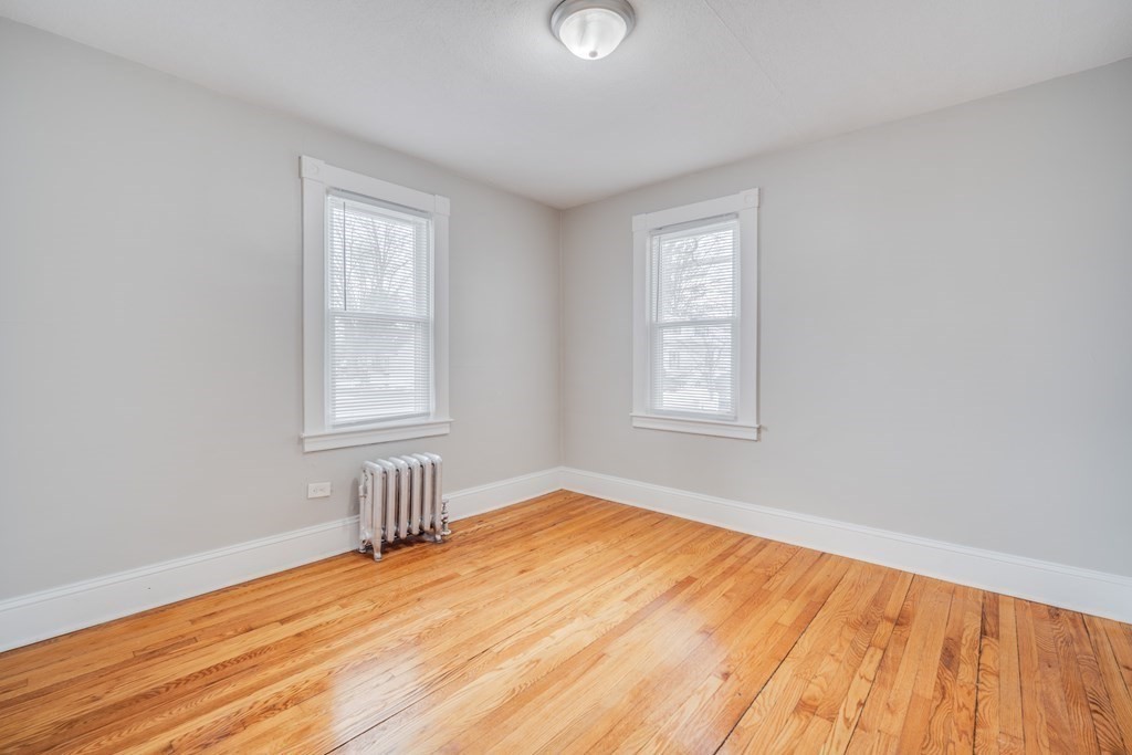 35 Stuart Street Springfield, MA 01119 - Photo 25 of 34 an empty room with wooden floor and windows