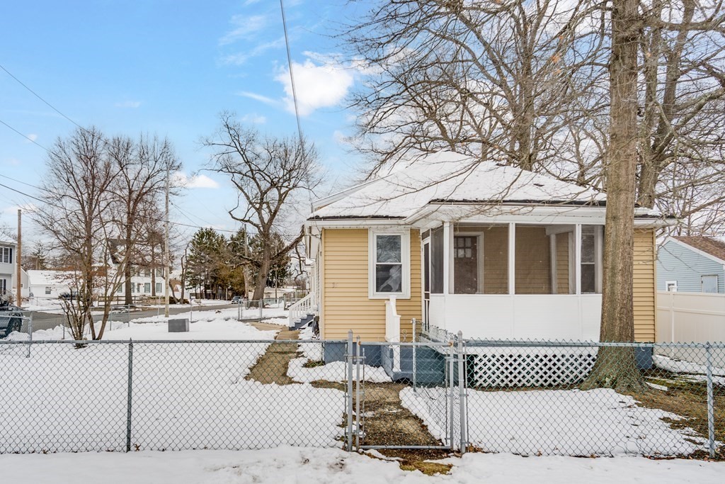 35 Stuart Street Springfield, MA 01119 - Photo 4 of 34 a view of a white house with a yard covered in snow