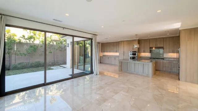 a open kitchen with stainless steel appliances granite countertop a refrigerator and a sink