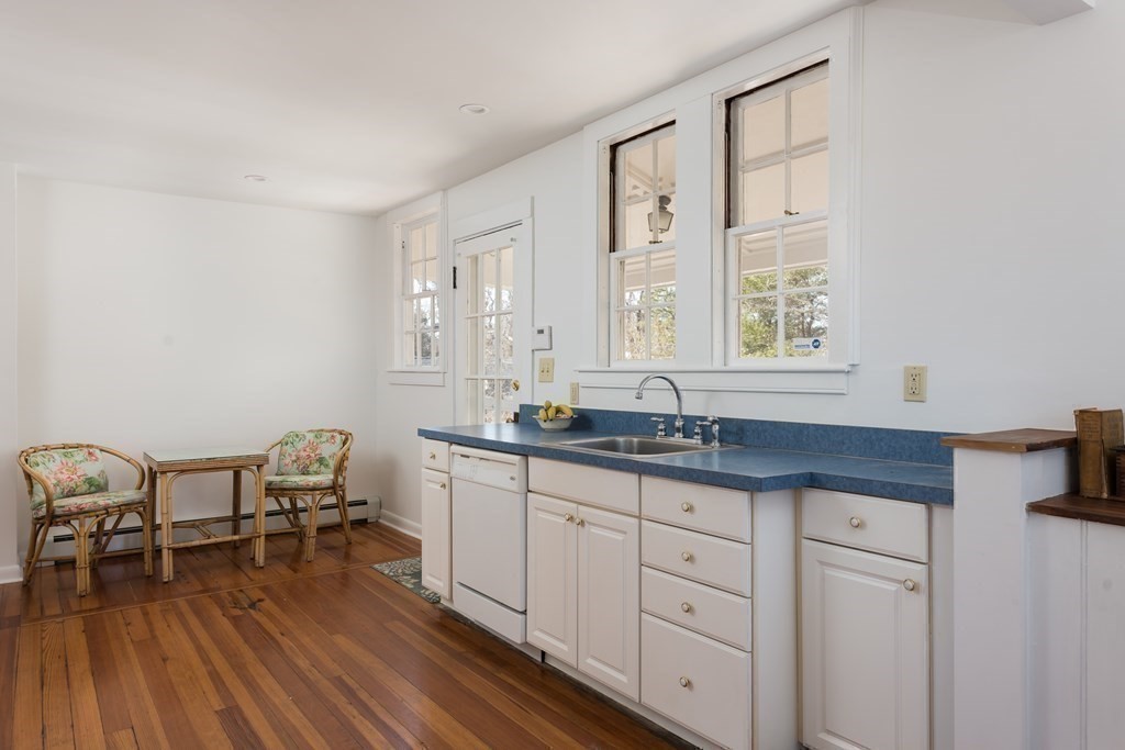 16 Jefferson Shores Road Wareham, MA 02532 - Photo 12 of 28 a kitchen with granite countertop a sink a stove cabinets and wooden floor
