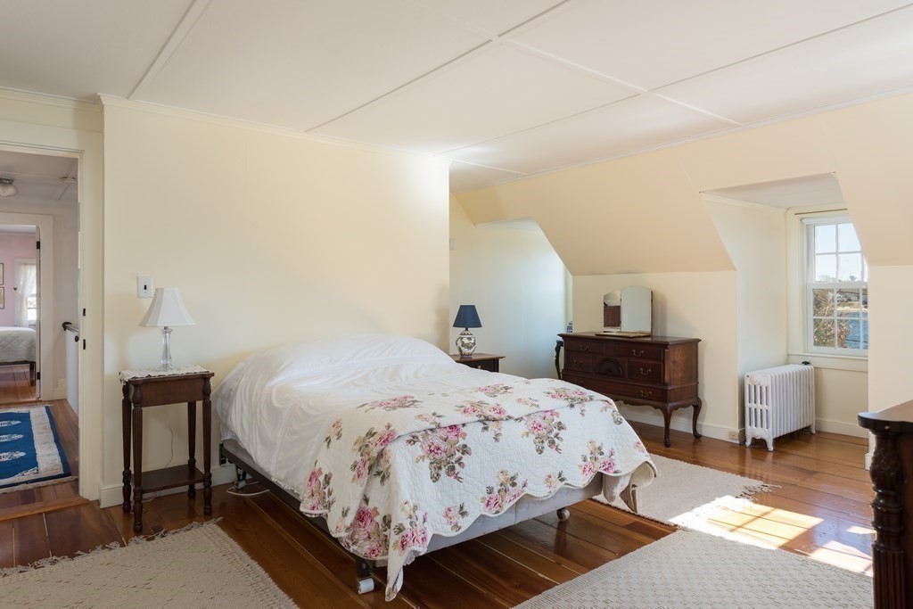 16 Jefferson Shores Road Wareham, MA 02532 - Photo 14 of 28 a bedroom with a bed a table and chair