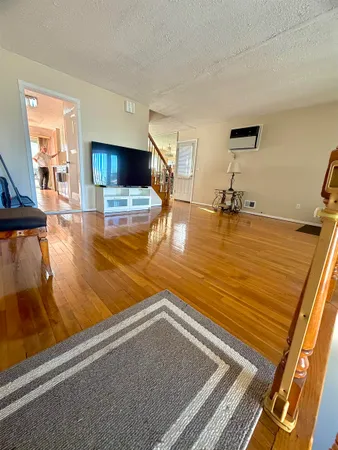 a view of a living room and kitchen with a sink