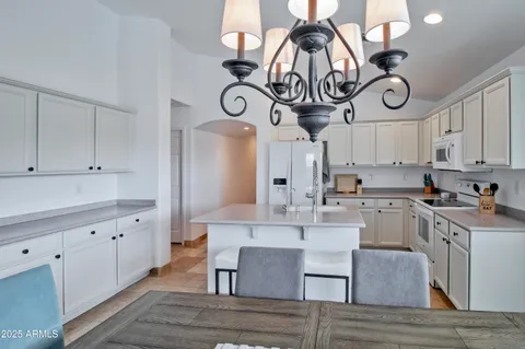 a kitchen with cabinets and wooden floor