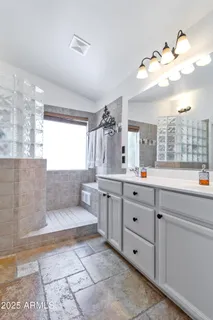 a bathroom with a double vanity sink a mirror and a