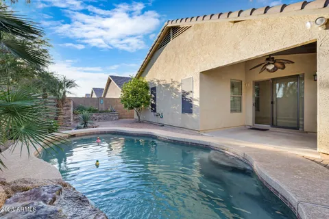 a swimming pool with outdoor seating and yard